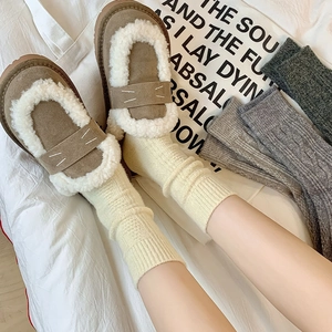 Women's khaki suede loafers with warm white plush trim and cable knit wool socks