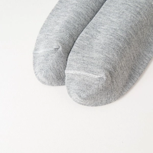 Macro detail of the seamless toe stitching on grey marl cotton business crew socks
