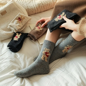 Detail of wool socks with cute teddy bear embroidery and colorful knit texture