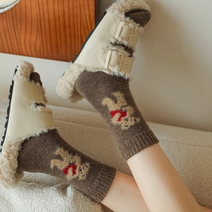 Detail of wool socks with bear embroidery and cozy lambskin slippers for winter comfort