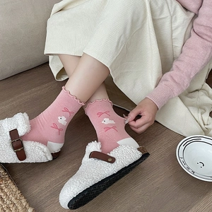 Pink knit mid-calf socks with bunny embroidery, ruffle cuffs and white plush slippers