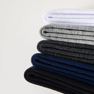 Close-up of ribbed cotton crew socks in white, grey, navy, and black color palette