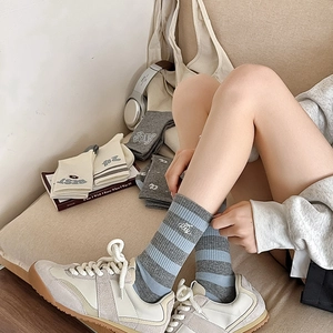 Detail of Korean style cotton socks with letter embroidery and blue striped pattern