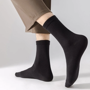 Close-up of black ribbed mid-calf crew socks showing high-quality cotton knit texture
