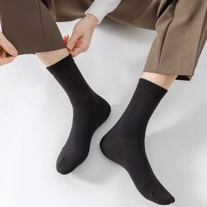 Detail of black cotton mid-calf socks with elastic cuffs for men business casual wear