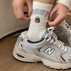 Japanese striped crew socks with cute bear embroidery and BEST lettering shown with shoes