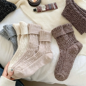 Thick cable knit wool socks in neutral earth tones with ribbed cuffs for winter