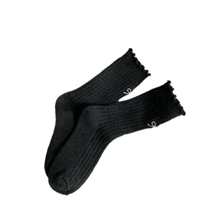 Thick wool socks in black with cute white bow embroidery and ruffled frill cuffs
