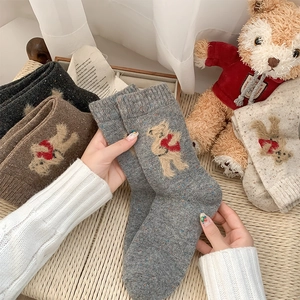 Close-up of wool blend thermal socks featuring a cute teddy bear embroidery detail