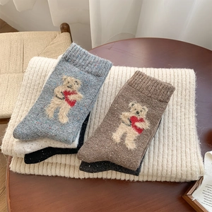Detailed texture of thick wool socks with 3D cute teddy bear embroidery for winter