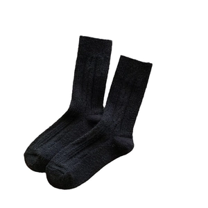 Thick wool socks for women with twisted knit pattern in solid black for winter warmth