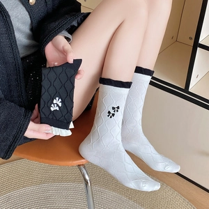 Detail of sweet Japanese style mid-calf socks with bow embroidery and white pearls