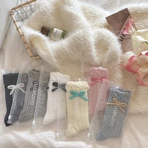 Detail of 6-pair pack cable knit baby socks with cute bows in various pastel colors