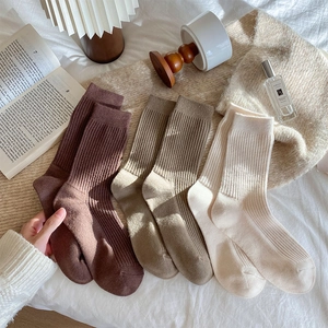 Cozy knit vertical stripe wool socks in brown and beige tones for winter warmth