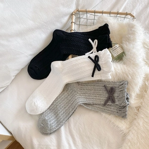 Three pairs of sweet style cotton socks in black, white and grey with cute bow details