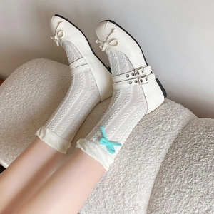 Detail of white Mary Jane shoes with ribbons and delicate lace floral socks for women
