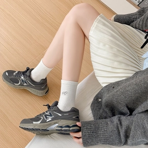 Women's heart embroidered crew socks paired with vintage dark gray mesh sports sneakers