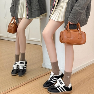Fashionable brown PU leather boston bag paired with brown socks and black casual shoes