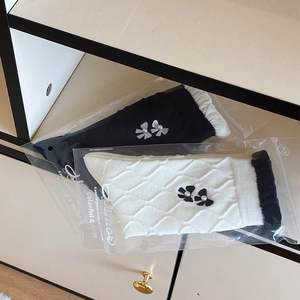 Detail of knit socks with silk bows and pearl beads in a display cabinet