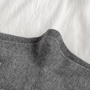 Macro detail of grey knitted cotton fabric showing fine texture and softness of crew socks