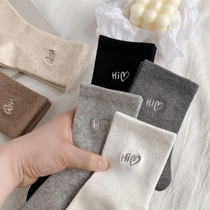 Detailed embroidery of Hi heart on ribbed cotton mid-calf socks in five neutral colors