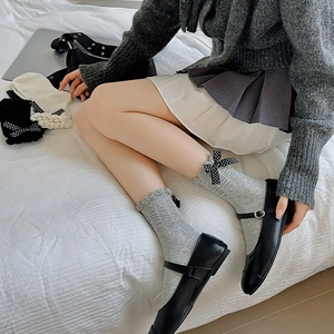 Japanese style frilly socks with bowknots and Mary Jane shoes in a lifestyle setting