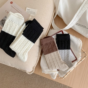 Detailed knit texture and color-block design of vintage twisted mid-calf socks