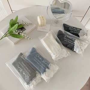 Detail of lace trim crew socks in various colors neatly arranged on a white table