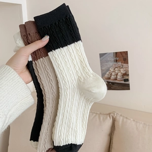 Close-up of retro cable-knit crew socks with contrast stitching for women