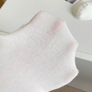 Detail of white mesh lace socks with delicate knit texture and sheer stretch material