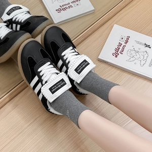 Retro black leather sneakers with white stripes, gum sole and foldable long tongue