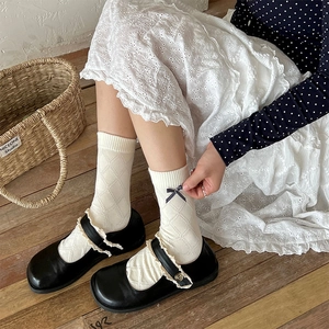 Floral crew socks with bow detail and Mary Jane shoes in a vintage aesthetic