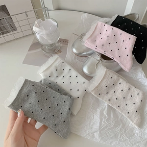 Detail of five-pair polka dot crew socks with lace trim in various colors like pink and grey