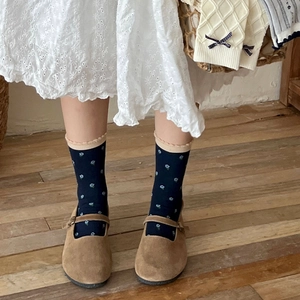 Vintage navy blue floral socks with lace edges and bow detail paired with suede shoes