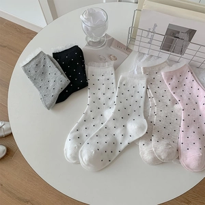 Close-up of sweet polka dot mid-calf socks with delicate lace trim in various colors