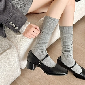 Japanese style grey ribbed calf socks paired with black Mary Jane shoes on wooden floor