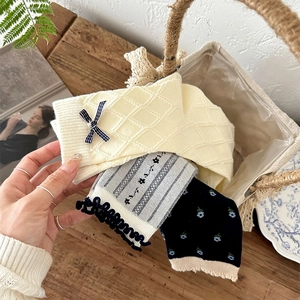 Three-pack vintage floral knit socks with bows and ruffled edges in a wicker basket