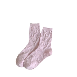 Pink crew socks with embossed 3D heart patterns made of soft cotton blend knit