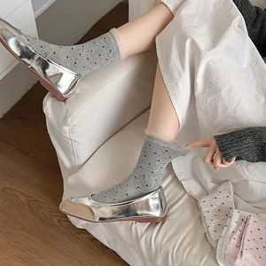 Detail of sweet mesh lace trim socks with polka dots shown on model with silver shoes