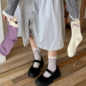 Detail of purple floral cotton socks with lace trim and cute bow accent for women
