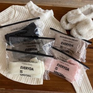 Detailed set of five-color knitted leg warmers in branded zipper packaging for storage