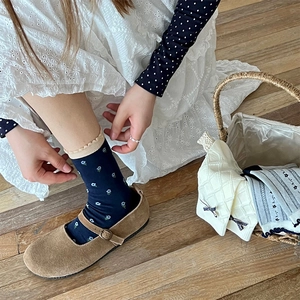 Vintage floral crew socks with navy base and ruffle trim worn with Mary Jane shoes