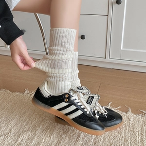 Stretchy vertical ribbed calf socks in off-white cotton blend fabric shown with sneakers