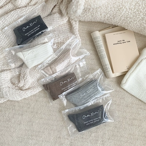 Detailed view of six pairs of ribbed cotton socks in neutral tones with zipper bags