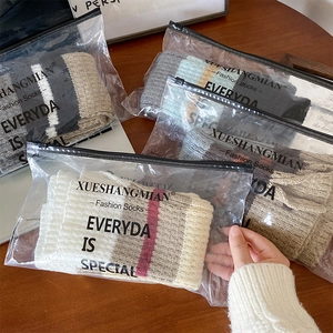Detailed view of striped knit leg warmers in individual frosted zipper packaging bags