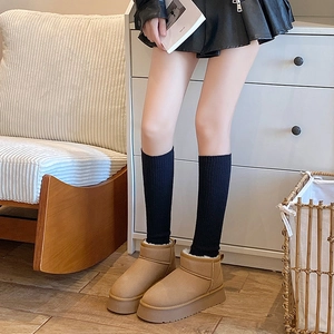 Detail of tan suede platform boots with thick wool lining and cozy winter style