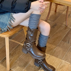Brown leather ankle boots with metal buckles and dark grey wool leg warmers
