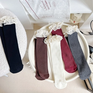 Detailed view of vintage lace trim on ribbed knit socks in assorted Morandi colors