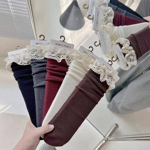 Detail of vintage lace ruffled cuffs on assorted knit crew socks in various colors