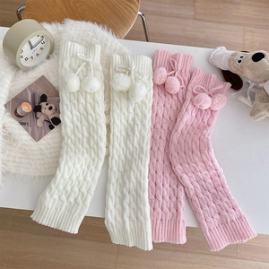 Detailed cable knit leg warmers in pink and white with cute pom-pom drawstring accents